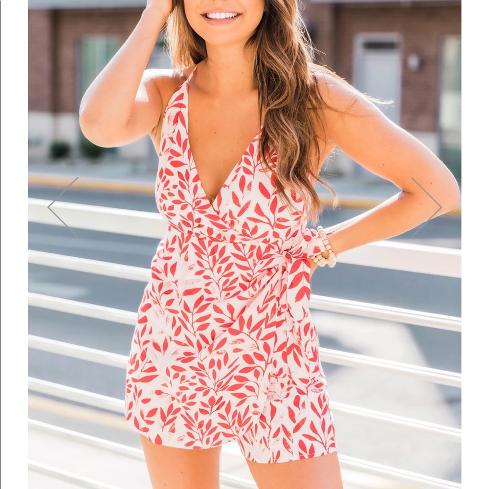 Pink Lily “Compliments all day” floral romper. NWT